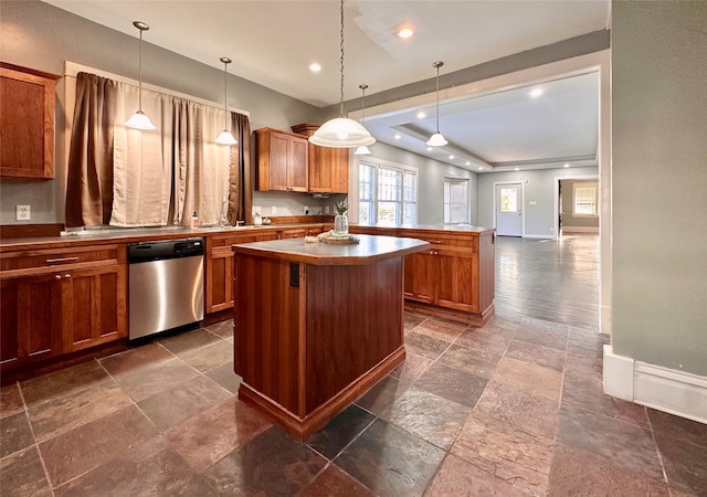 kitchen featuring pendant lighting, dishwasher, sink, and a kitchen island