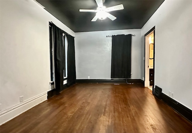 empty room featuring dark hardwood / wood-style floors and ceiling fan