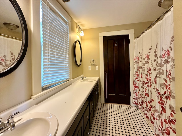 bathroom featuring vanity and curtained shower