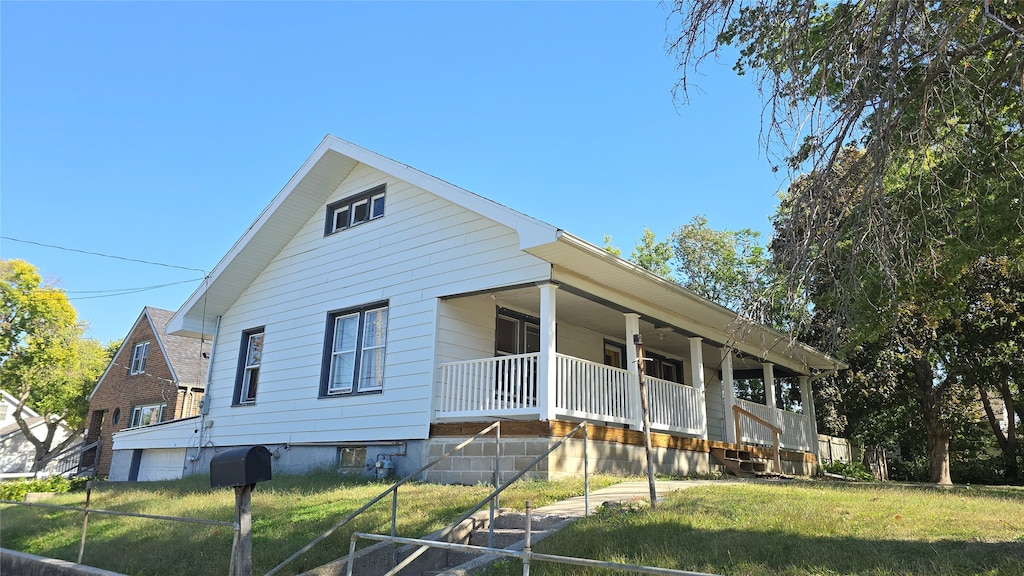 view of front of house with a front yard and a porch