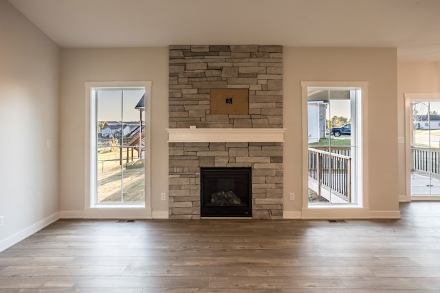 unfurnished living room with a fireplace and hardwood / wood-style floors