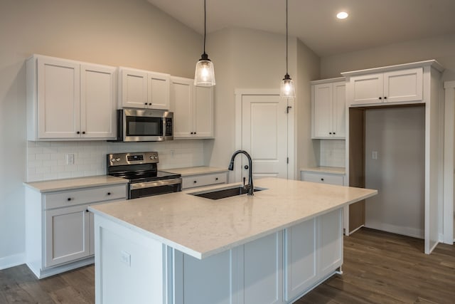 kitchen featuring white cabinets, a kitchen island with sink, stainless steel appliances, and sink