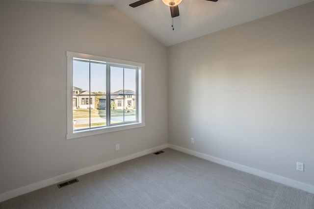 carpeted empty room with vaulted ceiling and ceiling fan