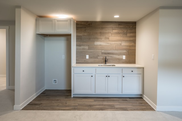 kitchen with sink, light hardwood / wood-style flooring, and white cabinets