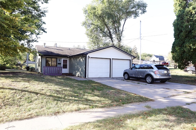 ranch-style house featuring a front yard and a garage