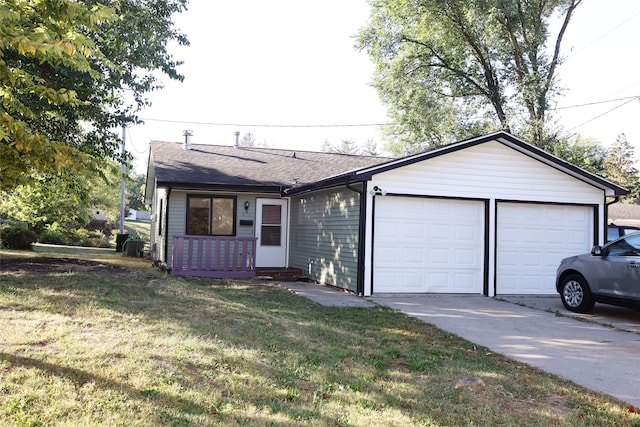 ranch-style home featuring a garage and a front lawn