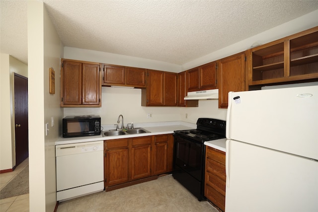 kitchen with light tile patterned floors, a textured ceiling, sink, and black appliances