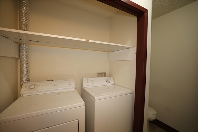 washroom featuring a textured ceiling and separate washer and dryer