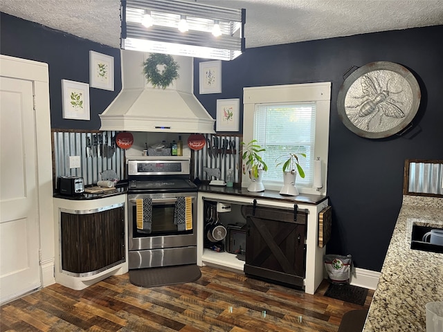 kitchen featuring custom exhaust hood, a textured ceiling, dark hardwood / wood-style floors, and stainless steel electric range