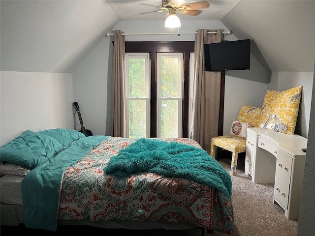 carpeted bedroom with vaulted ceiling and ceiling fan