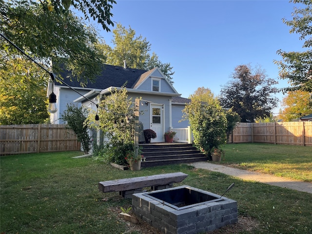 rear view of property with a lawn