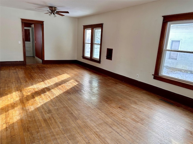 empty room featuring ceiling fan and light hardwood / wood-style flooring