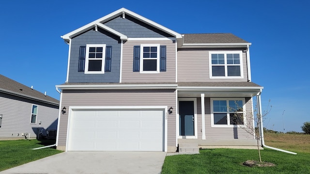 view of front of property featuring a front lawn and a garage