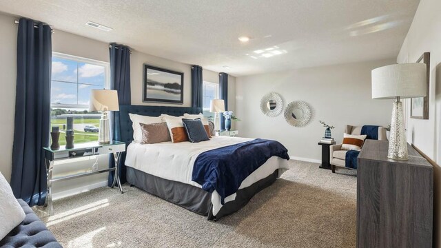 carpeted bedroom with a textured ceiling