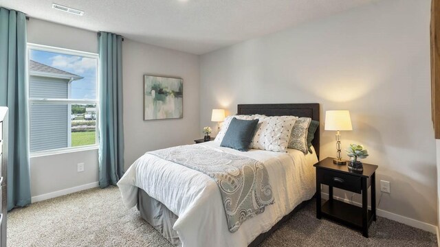 carpeted bedroom featuring a textured ceiling