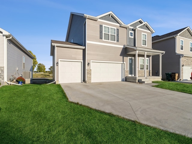 view of front of home with a front lawn, central AC unit, and a garage