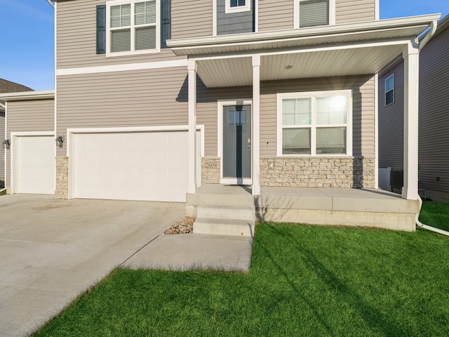 view of front of house featuring a front yard and a garage