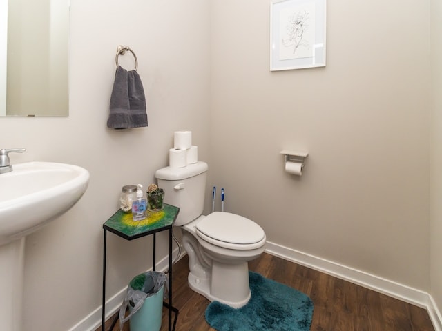 bathroom with hardwood / wood-style floors and toilet