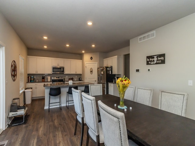 dining room with dark wood-type flooring