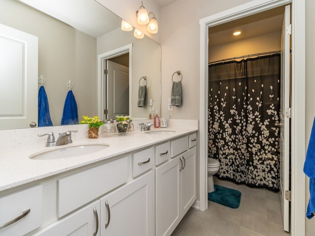 bathroom with vanity, tile patterned flooring, and toilet