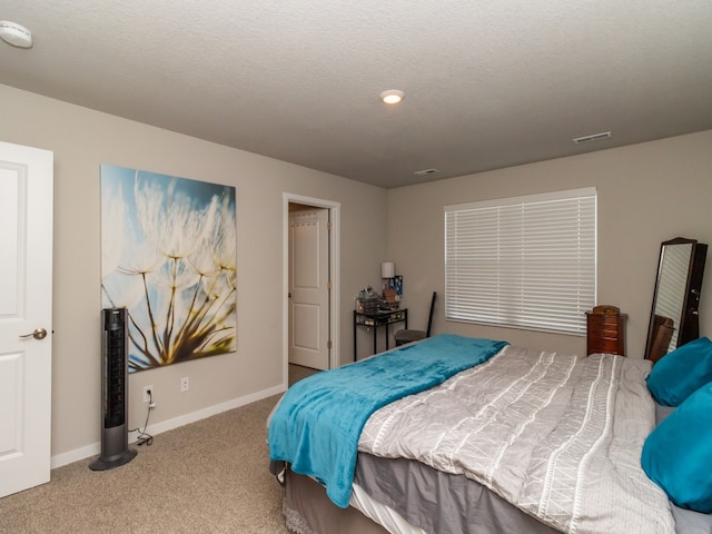 carpeted bedroom with a textured ceiling