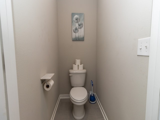 bathroom featuring tile patterned flooring and toilet