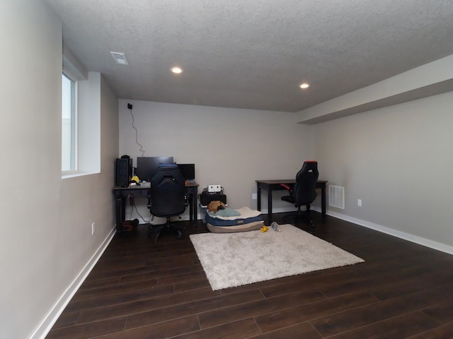 office area with a textured ceiling and dark hardwood / wood-style floors