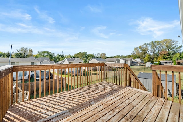 wooden deck featuring a yard