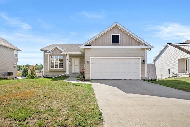 view of front of property featuring cooling unit, a front yard, and a garage