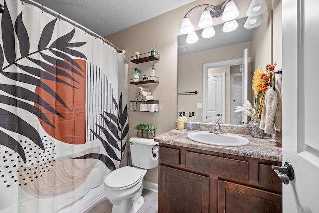 full bathroom featuring shower / bath combination with curtain, a textured ceiling, hardwood / wood-style floors, vanity, and toilet