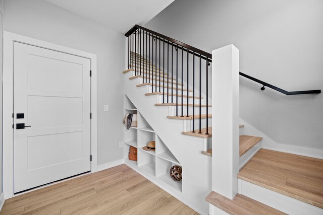 stairs featuring baseboards and wood finished floors