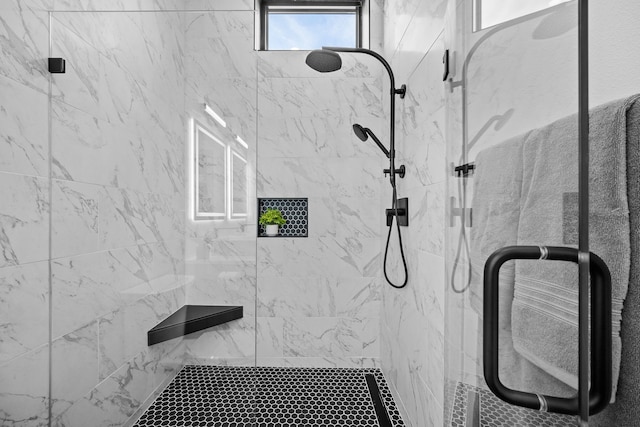 bathroom with a shower with door