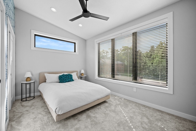 bedroom with lofted ceiling, light colored carpet, and baseboards