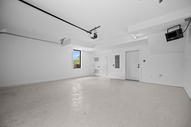 garage featuring a garage door opener and electric panel