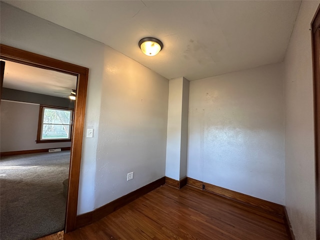 spare room with wood-type flooring and ceiling fan