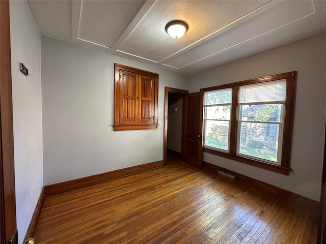 spare room with wood-type flooring