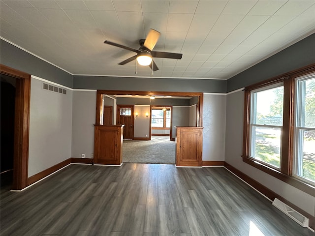 spare room featuring dark hardwood / wood-style floors, ceiling fan, and a wealth of natural light