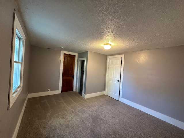 unfurnished bedroom featuring carpet floors and a textured ceiling