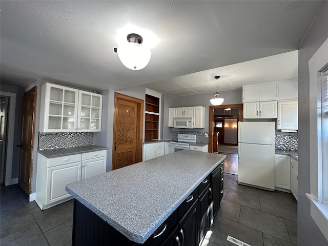 kitchen featuring white cabinets, white appliances, a kitchen island, decorative light fixtures, and decorative backsplash