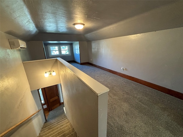 bonus room featuring dark carpet, lofted ceiling, and a textured ceiling