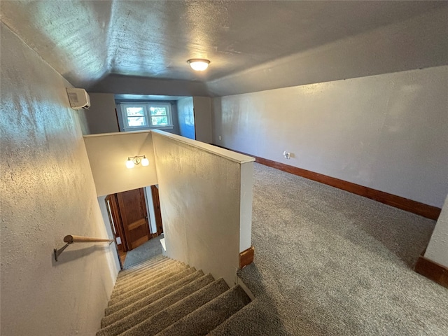 stairs with vaulted ceiling and carpet