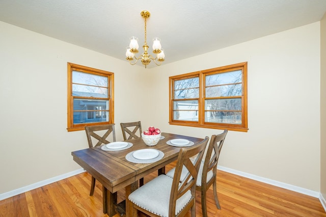 dining room with an inviting chandelier and light wood-type flooring