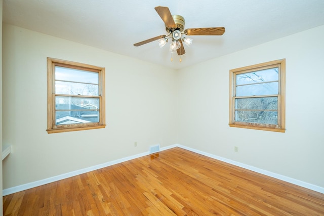 spare room with wood-type flooring and ceiling fan