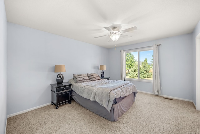 bedroom featuring light carpet and ceiling fan