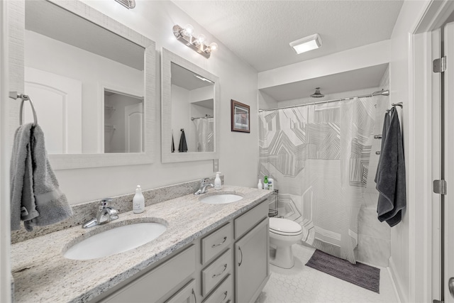 bathroom featuring vanity, a textured ceiling, tile patterned flooring, toilet, and a shower with curtain