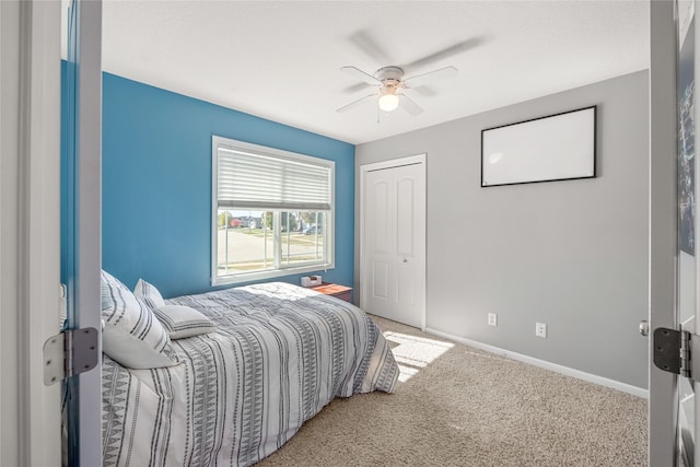 carpeted bedroom with a closet and ceiling fan