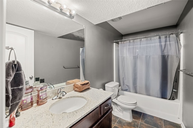 full bathroom featuring shower / tub combo, vanity, a textured ceiling, tile patterned flooring, and toilet