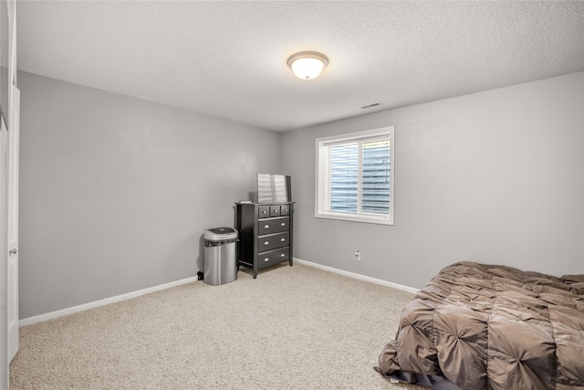 carpeted bedroom featuring a textured ceiling