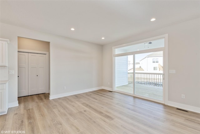 spare room featuring light wood-type flooring