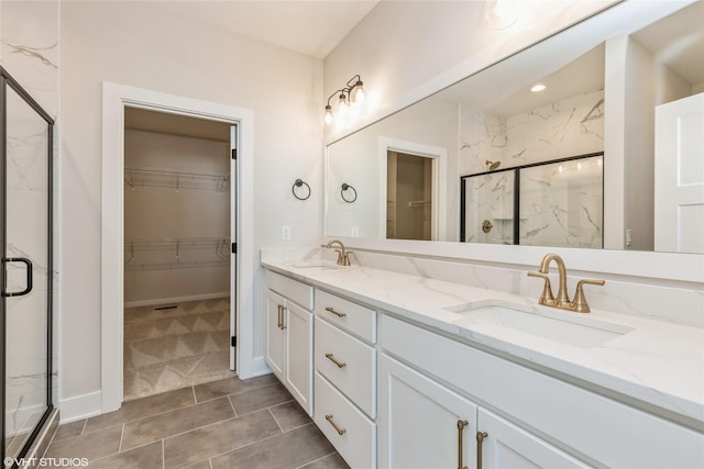 bathroom with vanity and a shower with door